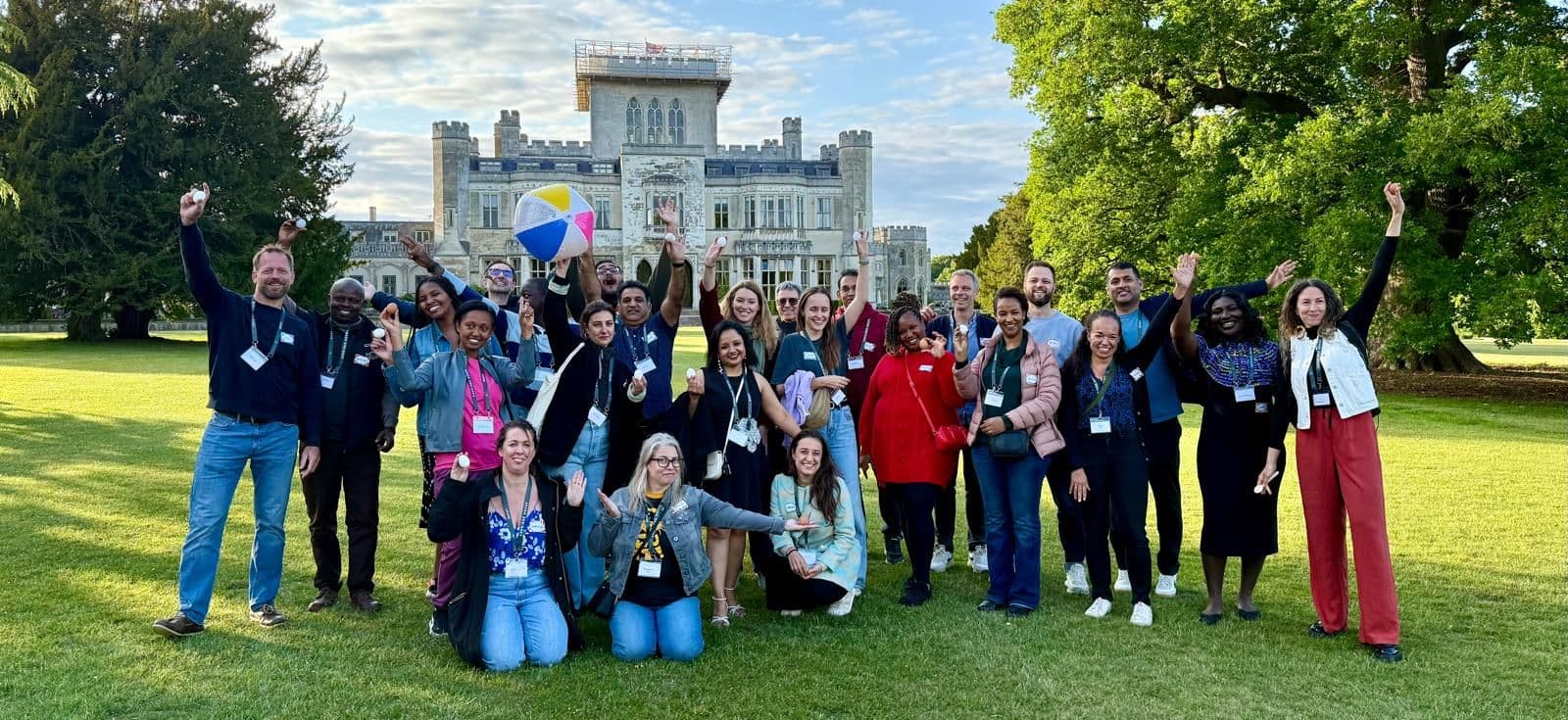 Group of executive education program participants celebrating outdoors